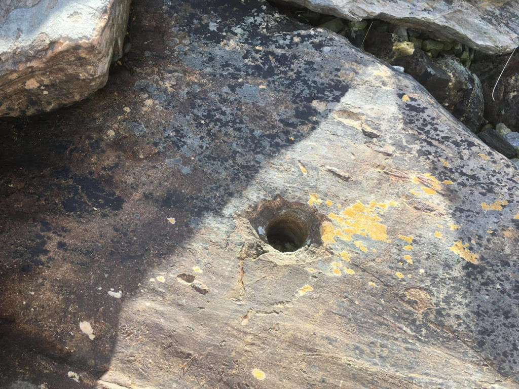 A drilled hole in a rock